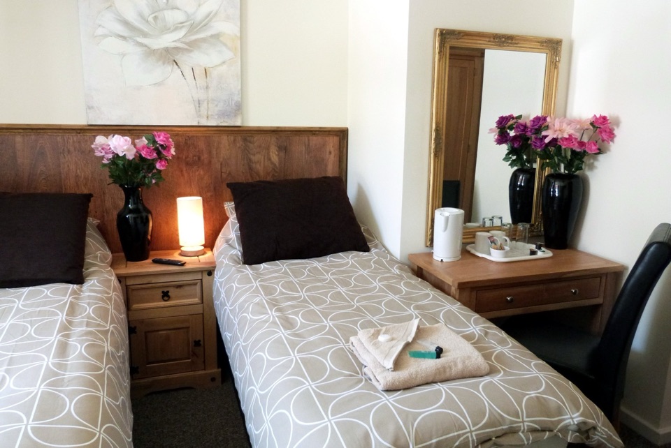 Single room with a bed, desk and window